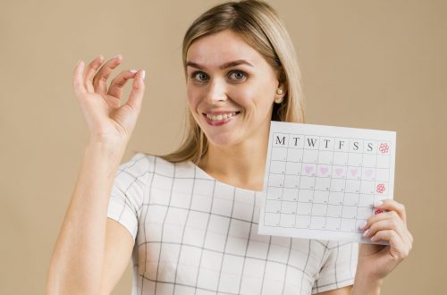 portrait-smiley-female-holding-menstruation-calendar